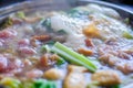 Close up view of hotpot with meat beef sliced and vegetables. Shabu Shabu is style beef in hotpot dish of thinly sliced meat