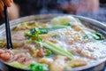 hotpot with meat beef sliced and vegetables. Shabu Shabu is style beef in hot pot dish of thinly sliced meat and vegetables boiled