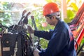 Close up view of hydraulic pipes of heavy industry machine. Mechanic repairing hydraulic hose in drilling machine, Man in hard hat Royalty Free Stock Photo