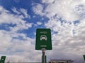 Close up view of IKEA green sign for electric car parking on blue sky and white clouds background. Europe. Royalty Free Stock Photo
