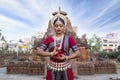 Close up View of Indian classical Odissi dancer posing in front of Mukteshvara temple.