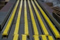 Close-up view of an industrial conveyor system, featuring parallel yellow tracks and cylindrical components in a utilitarian Royalty Free Stock Photo