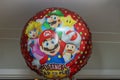 Close-up view of inflatable balloon with children favorite cartoon characters on white wall background.