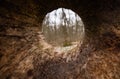 A close up view from inside the old rotten fallen tree with hollow. Almost perfect round hole. Unusual inside view of