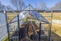 Close up view of interior of greenhouse with wooden floor prepared for planting vegetables in spring.