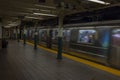 Close-up view of interior of New York subway station Astor Place with train moving out of focus. New York.