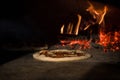 close up view of italian pizza baking in brick oven Royalty Free Stock Photo