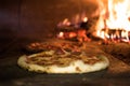 close up view of italian pizza baking in brick oven Royalty Free Stock Photo