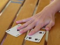 Close-up View of Italian Playing Cards Moved by Players Hands above a Table with Wooden Staves