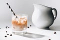 close up view of jag of milk and glass of cold brewed coffee with straw Royalty Free Stock Photo