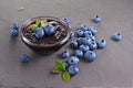 Close up view jam in glass bowl with fresh ripe blueberry and leaves