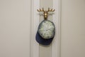 Close up view of cap on wall holder in form of golden horns. Interior details. Royalty Free Stock Photo