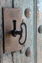 Close-up view of a key in the lock of an antique wooden door Royalty Free Stock Photo