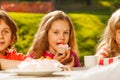 Close up view of kids drinking tea with cupcakes Royalty Free Stock Photo