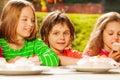 Close up view of kids sit outside at table Royalty Free Stock Photo
