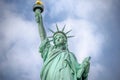 Close Up View of Lady Liberty Statue. Holding the Torch with the Golden Flame and the Tablet. New York City, USA