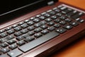 Close-up View of Laptop Keyboard on Office Desk with Productivity Tools and Stationery