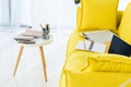 close up view of laptop, notebooks and folders on yellow sofa Royalty Free Stock Photo