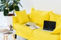 close up view of laptop, notebooks and folders on yellow sofa Royalty Free Stock Photo