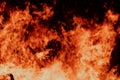 Close-up view of a large fire with intense flames against a dark background Royalty Free Stock Photo