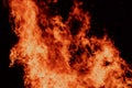 Close-up view of a large fire with intense flames against a dark background Royalty Free Stock Photo