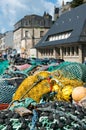 Close up view of large pile of different fishing nets used for offshore fishing and trawling laying on the docks in a French