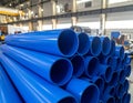 Stack of Blue PVC Plastic Pipes in an Industrial Warehouse Setting image photo Royalty Free Stock Photo