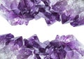 Close up view of large violet amethyst crystal cluster border isolated with white background. Royalty Free Stock Photo