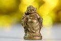 Close up view of Laughing Buddha statue against golden light background Royalty Free Stock Photo