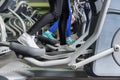 Close up view on legs of people exercising on the crosstrainer m