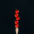 close up view of levitating cherry tomatoes on fork