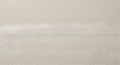 A close-up view of a light-colored fabric surface with a detailed woven texture Royalty Free Stock Photo