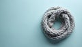 Close-up view of a light gray knitted scarf with a thick cable knit pattern and soft texture. The cozy accessory is coiled on a Royalty Free Stock Photo