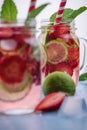 Close up view on lime and strawberry detox drink in glass mason jars on a blue background 3 Royalty Free Stock Photo