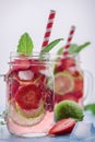 Close up view on lime and strawberry detox drink in glass mason jars on a blue background 4 Royalty Free Stock Photo