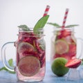 Close up view on lime and strawberry detox drink in glass mason jars on a blue background 15 Royalty Free Stock Photo