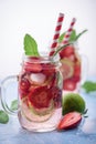 Close up view on lime and strawberry detox drink in glass mason jars on a blue background 7 Royalty Free Stock Photo