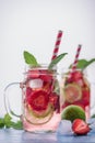 Close up view on lime and strawberry detox drink in glass mason jars on a blue background 13 Royalty Free Stock Photo