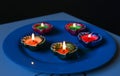 A close-up view of lit diyas arranged on plate Royalty Free Stock Photo