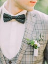 The close-up view of the little boutonniere on the jacket of the groom.