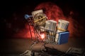 close up view of little shopping trolley full of coins isolated on brown.Gold coins in shopping online cart isolated on brown back Royalty Free Stock Photo