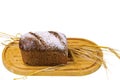 Close up view of  loaf rye bread and rye ears on wooden cutting board isolated white background.  Food concept. Royalty Free Stock Photo