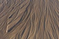 Close up view looking down on patterns in a wet sandy beach, showing textures, shapes and ripples number 2 Royalty Free Stock Photo