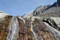 A close up view looking up at falling water from a creek rolling down the side of a steep mountain with the mountain Royalty Free Stock Photo