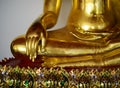 Close up view of the low hand golden buddha statue sitting meditation with copy space and sunlight Royalty Free Stock Photo