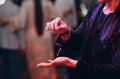 close up view of magician hand showing focus with flying object rubber band on a hair