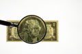 Close up view of magnifying glass over two dollar bill. Banknote. Royalty Free Stock Photo