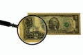 Close up view of magnifying glass over two dollar bill. Banknote. Royalty Free Stock Photo