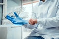 Close up view of male doctor`s hands putting on blue sterilized surgical gloves in the medical clinic Royalty Free Stock Photo