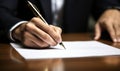 Close-up view of a male hand holding a pen while signing a legal contract with a focused and serious demeanor Royalty Free Stock Photo